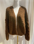 Brown knitted cardigan on a mannequin against a white background