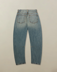 Pair of blue jeans on a beige background