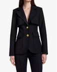 Black suit with gold buttons worn by a model on a white background