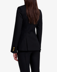 Person wearing a black suit on a white background