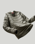 Folded puffer jacket on a light gray background