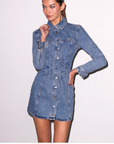 Woman wearing a denim dress on a white background
