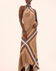 Woman wearing a patterned dress with a plain background