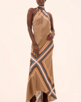 Woman wearing a patterned dress on a beige background