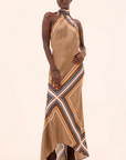 Woman wearing a patterned dress on a beige background