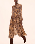 Woman wearing a patterned dress on a beige background