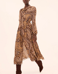 Model wearing a patterned dress on a plain background