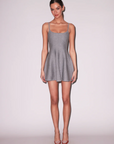 Woman wearing a gray dress against a white background