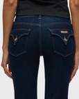 Dark blue jeans with a visible brand logo on a white background