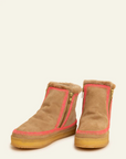 Pair of brown suede boots with pink interior lining on a white background