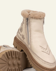 White winter boot with fur trim and decorative stitching on a white background