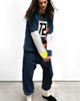 Person wearing a dark blue outfit with a number 72 on a white background
