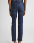 Blue jeans worn by a person on a white background