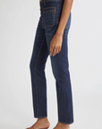 Person wearing dark blue jeans on a white background