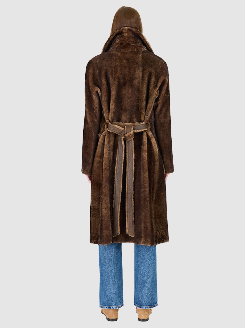 Brown fur coat worn by a person on a white background