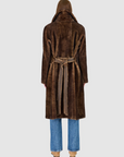 Brown fur coat worn by a person on a white background