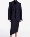 Woman wearing a black suit on a white background