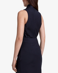 Woman wearing a sleeveless black dress on a white background