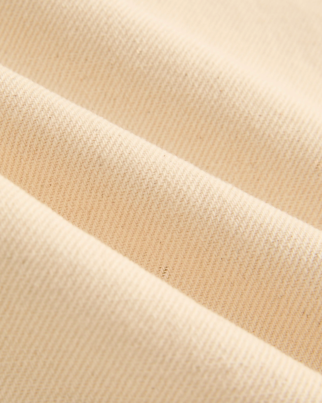 Close-up of beige fabric with a ribbed texture