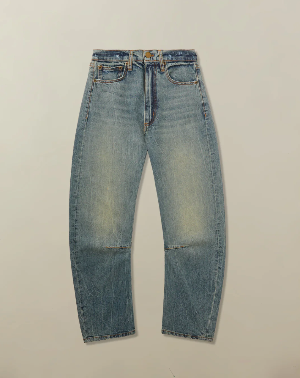 Pair of blue jeans on a beige background