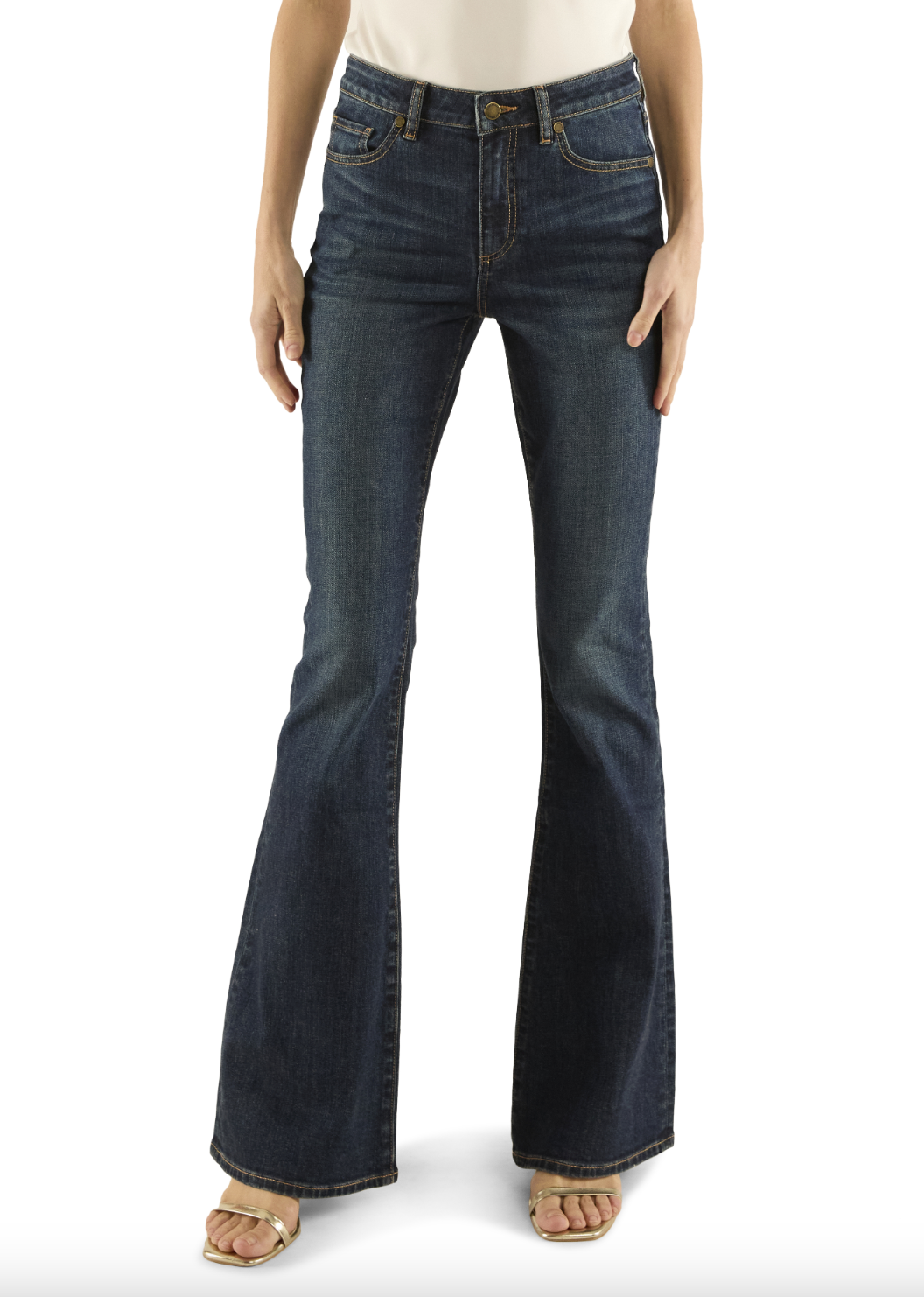 Dark blue flared jeans worn by a person on a white background