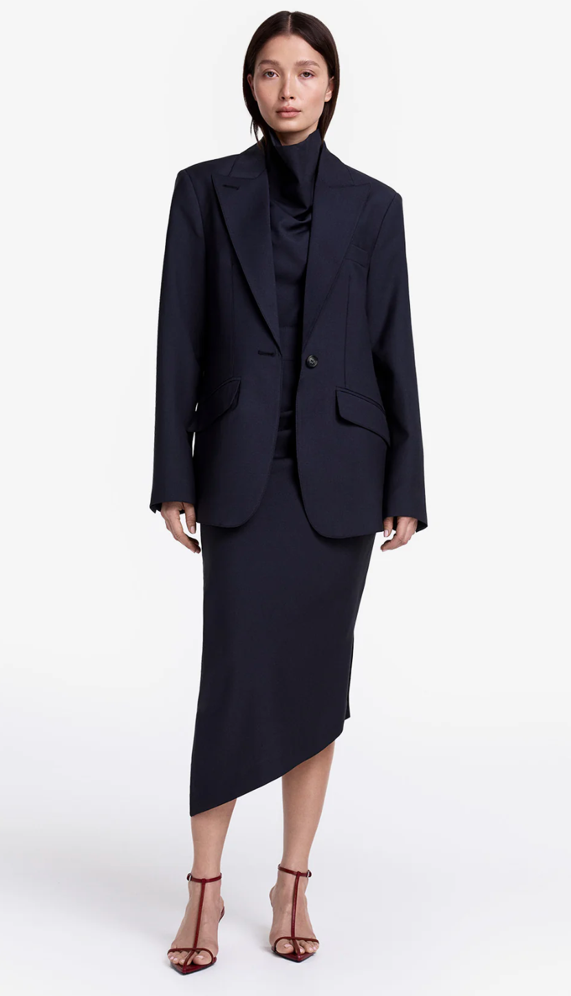Woman wearing a black suit on a white background