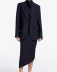 Woman wearing a black suit on a white background