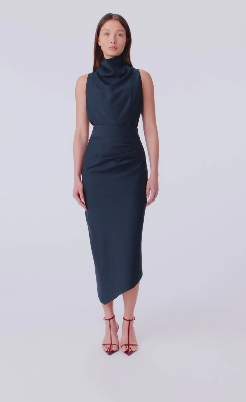Woman wearing a navy blue dress on a white background
