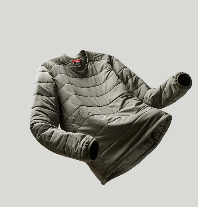 Folded puffer jacket on a light gray background
