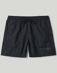 Black shorts with a brand logo on a light gray background