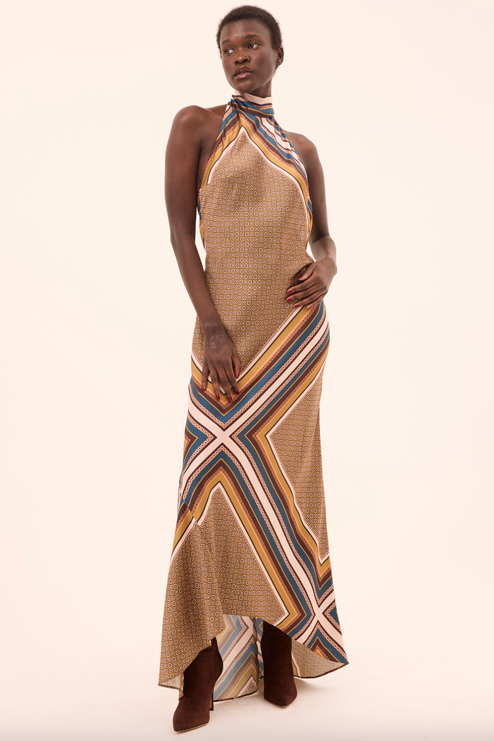 Woman wearing a patterned dress with a plain background