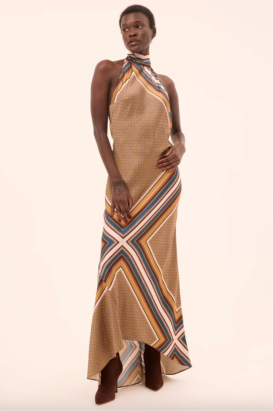 Woman wearing a patterned dress on a beige background