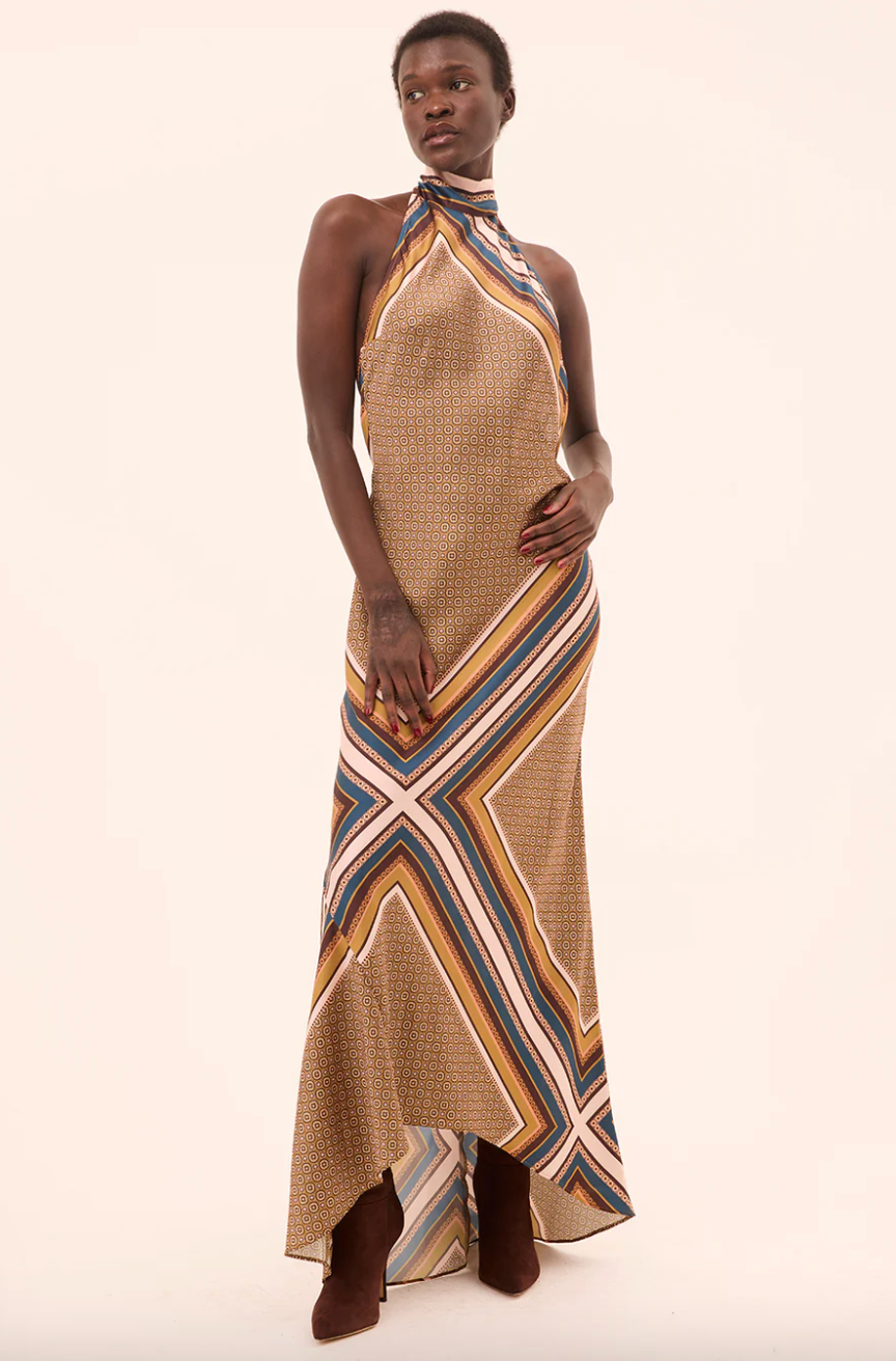 Woman wearing a patterned dress on a beige background
