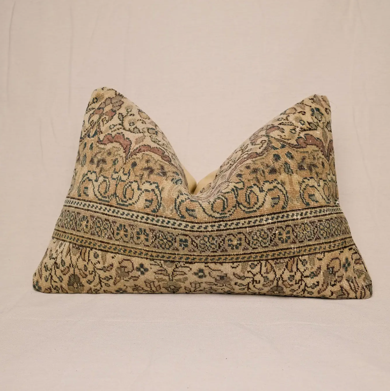 Decorative pillow with intricate pattern on a beige background