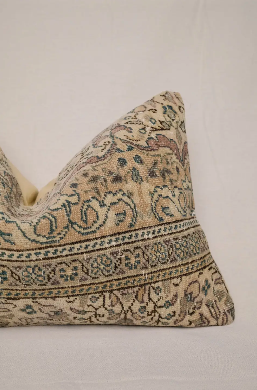 Decorative pillow with intricate patterns on a beige background