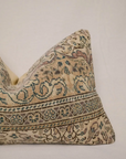 Decorative pillow with intricate patterns on a beige background