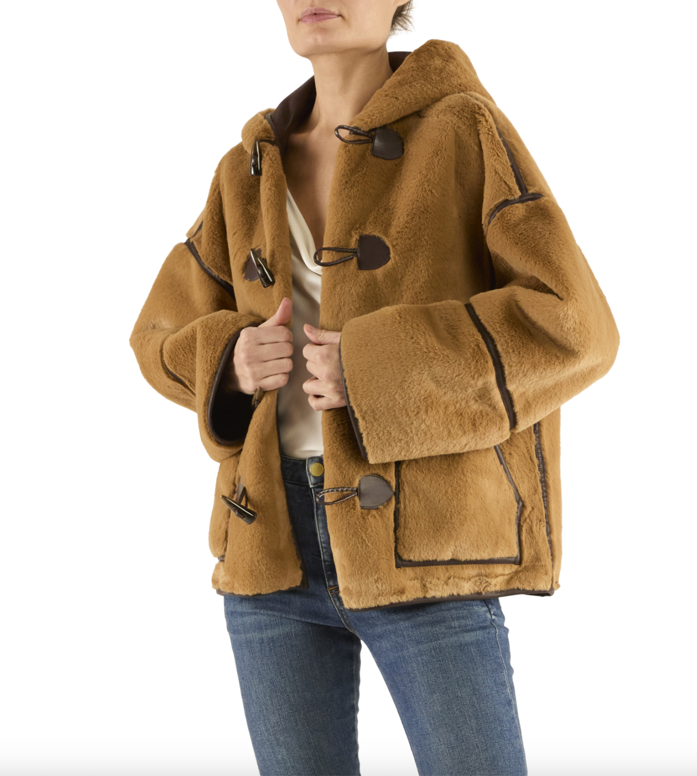 Person wearing a brown sheepskin coat with a white background