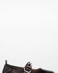 Black leather flat shoe with a buckle on a white background