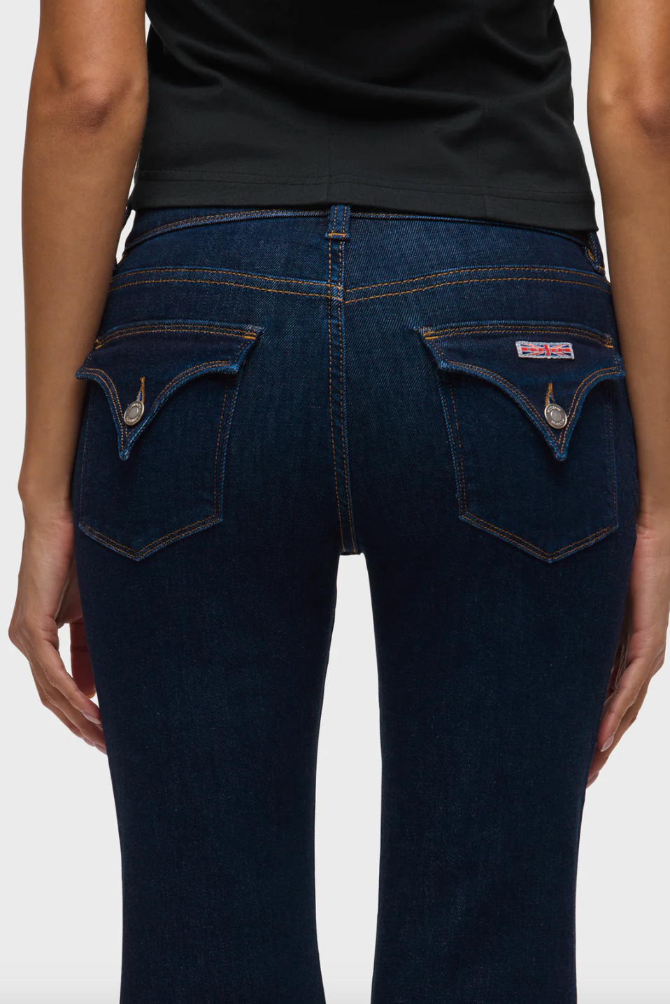 Dark blue jeans with a visible brand logo on a white background