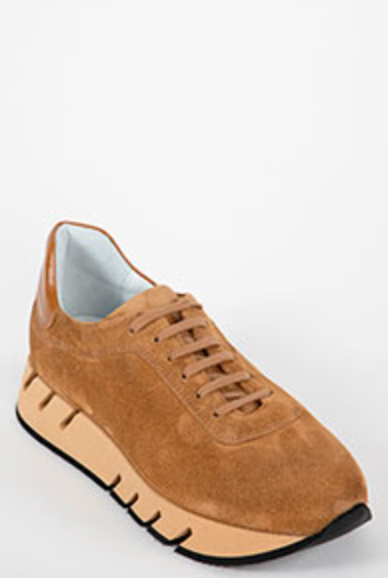 Tan sneaker with a white sole on a light gray background