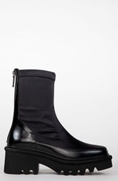 Black boot with a thick sole on a white background