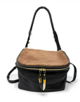 Black and brown handbag with a gold zipper on a white background