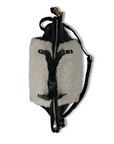 Backpack with gray shearling-like exterior and black leather accents on a white background