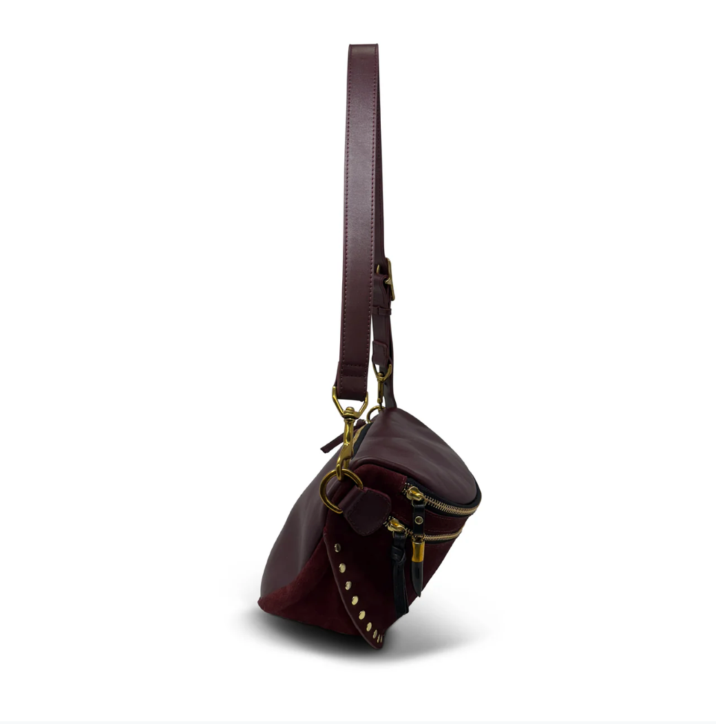 Brown leather bag with gold accents on a white background