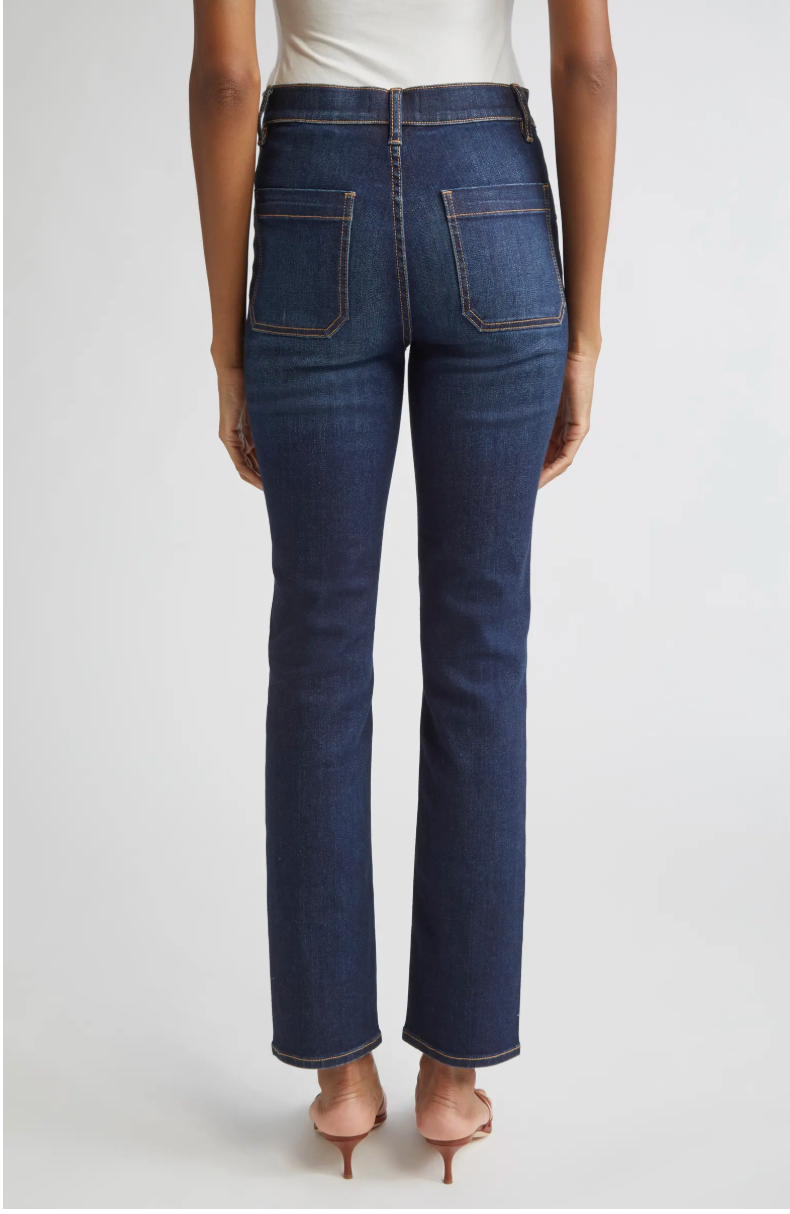 Blue jeans worn by a person on a white background