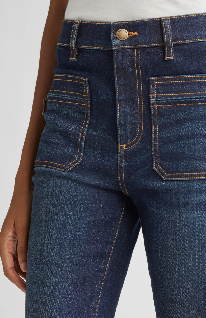 Close-up of dark blue jeans with a white background