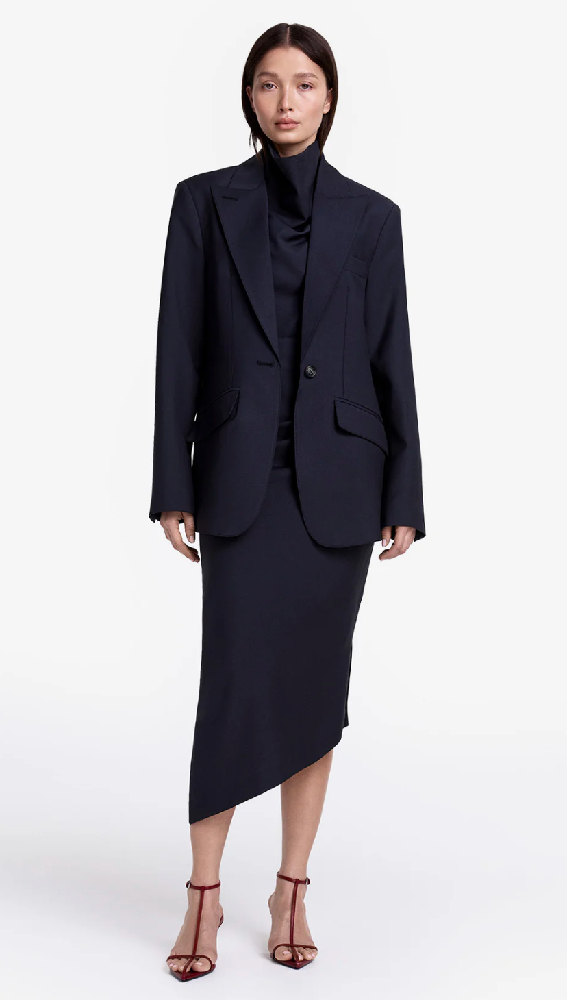 Woman wearing a black suit on a white background