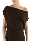Brown off-shoulder top worn by a model on a white background